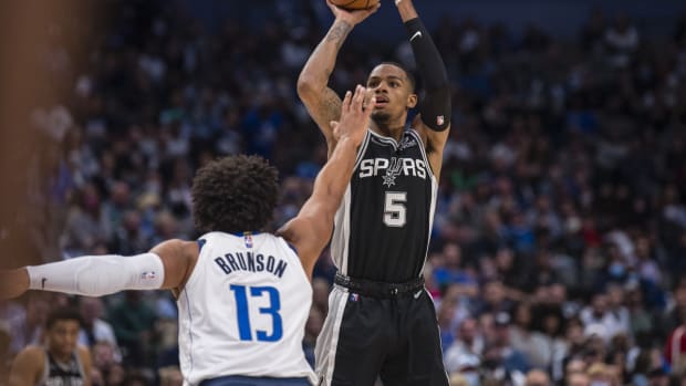 Oct 28, 2021; Dallas, Texas, USA; San Antonio Spurs guard Dejounte Murray (5) shoots over Dallas Mavericks guard Jalen Brunson (13) during the second half at the American Airlines Center. Mandatory Credit: Jerome Miron-USA TODAY Sports